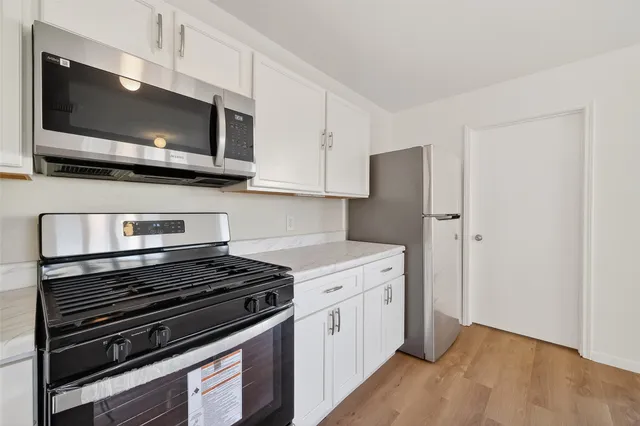 a kitchen with a stove and a microwave