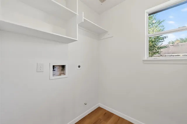 a view of small space with wooden floor and a window