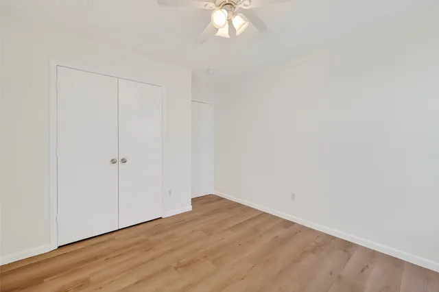 a view of a small space with wooden floor and a window