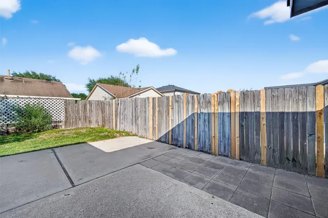 a view of backyard with tub and trees