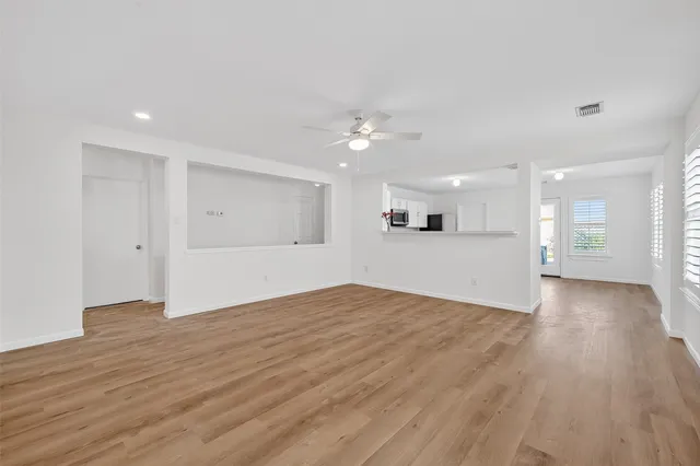 a view of kitchen and hall with wooden floor