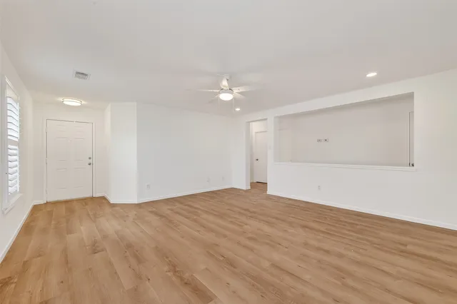 a view of an empty room and wooden floor