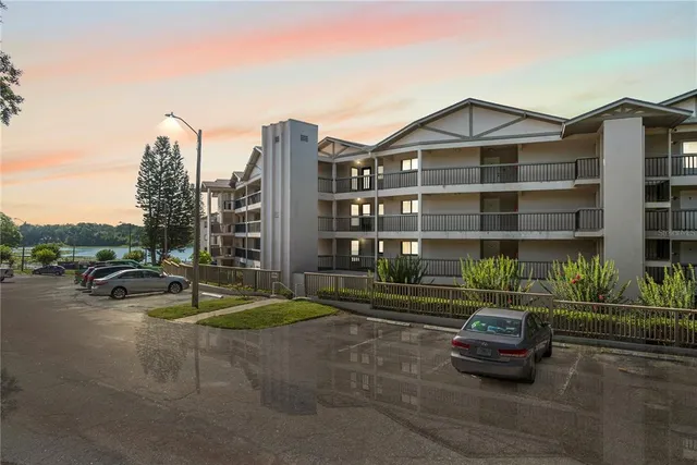 a car parked in front of a white house