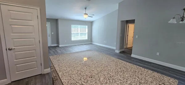 an empty room with windows and closet