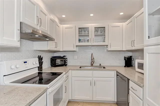 a bedroom with bed and a chandelier