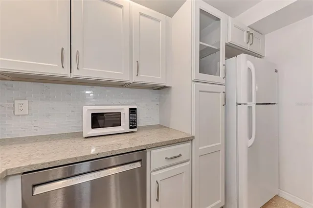 a bedroom with a large bed and a flat tv screen on dresser
