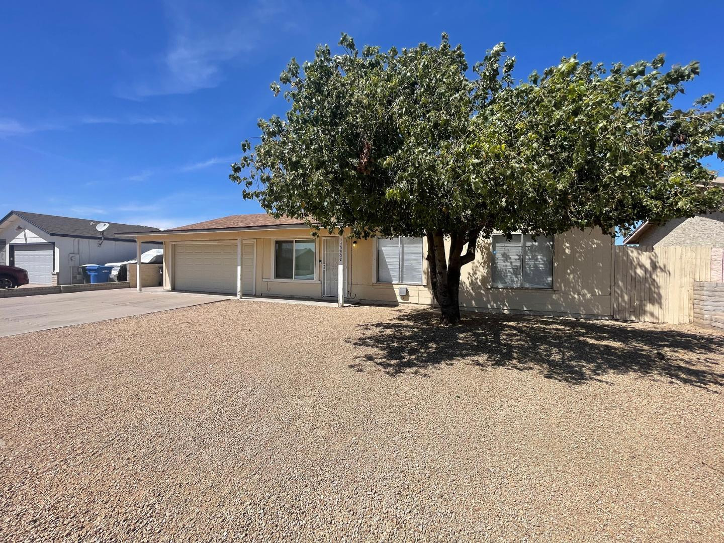 10902 West Montecito Avenue Phoenix, AZ 85037 - Photo 2 of 22 a front view of a house with a tree