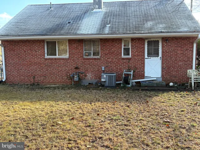 a view of a brick house with many windows