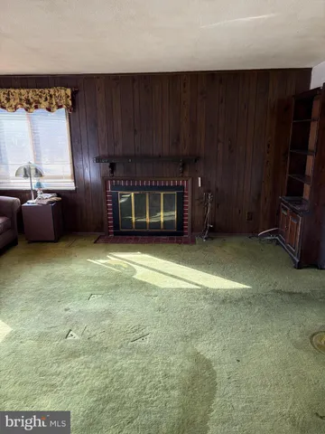 a view of a room with furniture and a window