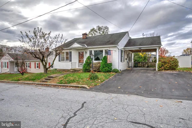 a front view of house with yard and green space