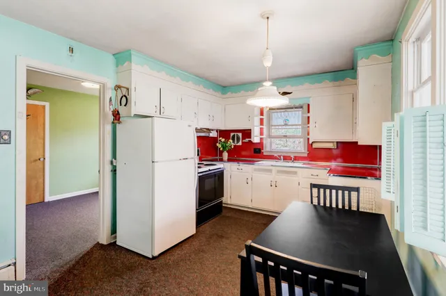 a kitchen with refrigerator cabinets and wooden floor
