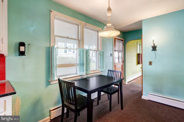 a dining room with furniture and window