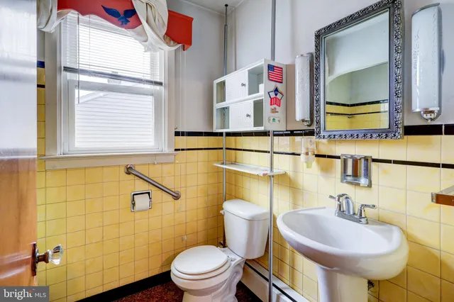a bathroom with a sink mirror vanity and toilet