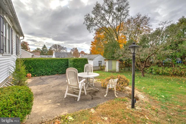 a view of a house with a yard patio and furniture