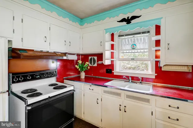 a kitchen with stainless steel appliances cabinets and a window