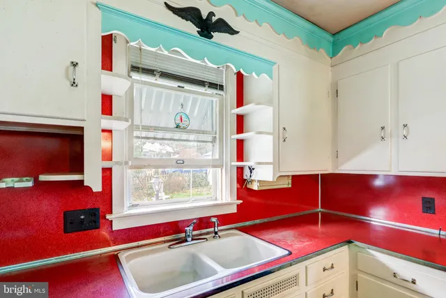 a room with pool table and a large window