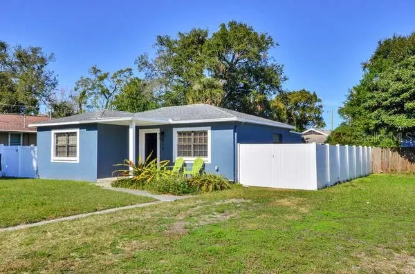 a view of a house with yard and a garden
