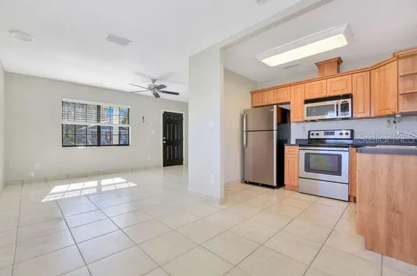 a kitchen with stainless steel appliances granite countertop a refrigerator and a stove top oven