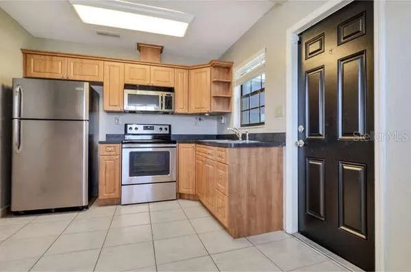 a kitchen with stainless steel appliances a refrigerator and a stove top oven