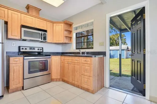 a kitchen with stainless steel appliances granite countertop a stove and a microwave