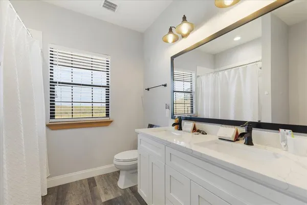 a bathroom with a double vanity sink and a mirror