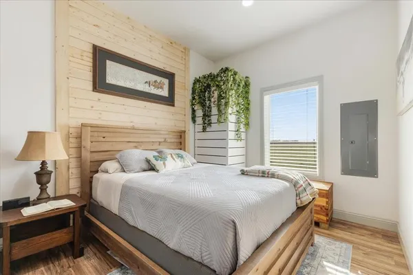 a bedroom with a bed and a night stand