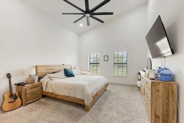 a bedroom with a bed a couch and a window