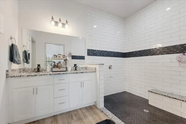 a bathroom with a sink a toilet and mirror