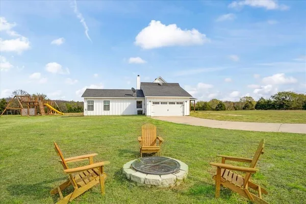 a front view of a house with swimming pool having outdoor seating