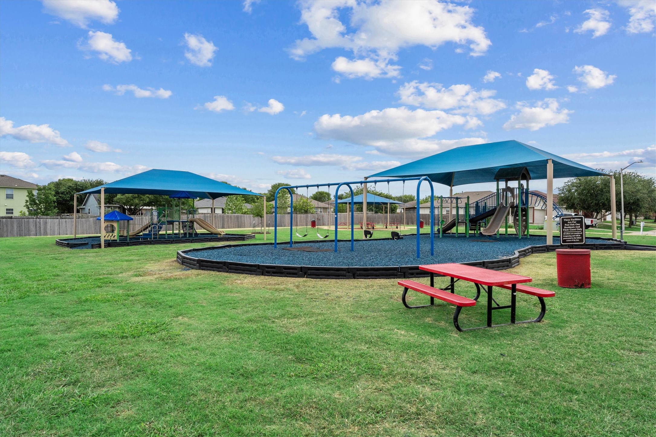 172 Discovery Kyle, TX 78640 - Photo 21 of 21 Neighborhood playground with covered play areas, swings, and open green space for outdoor fun.