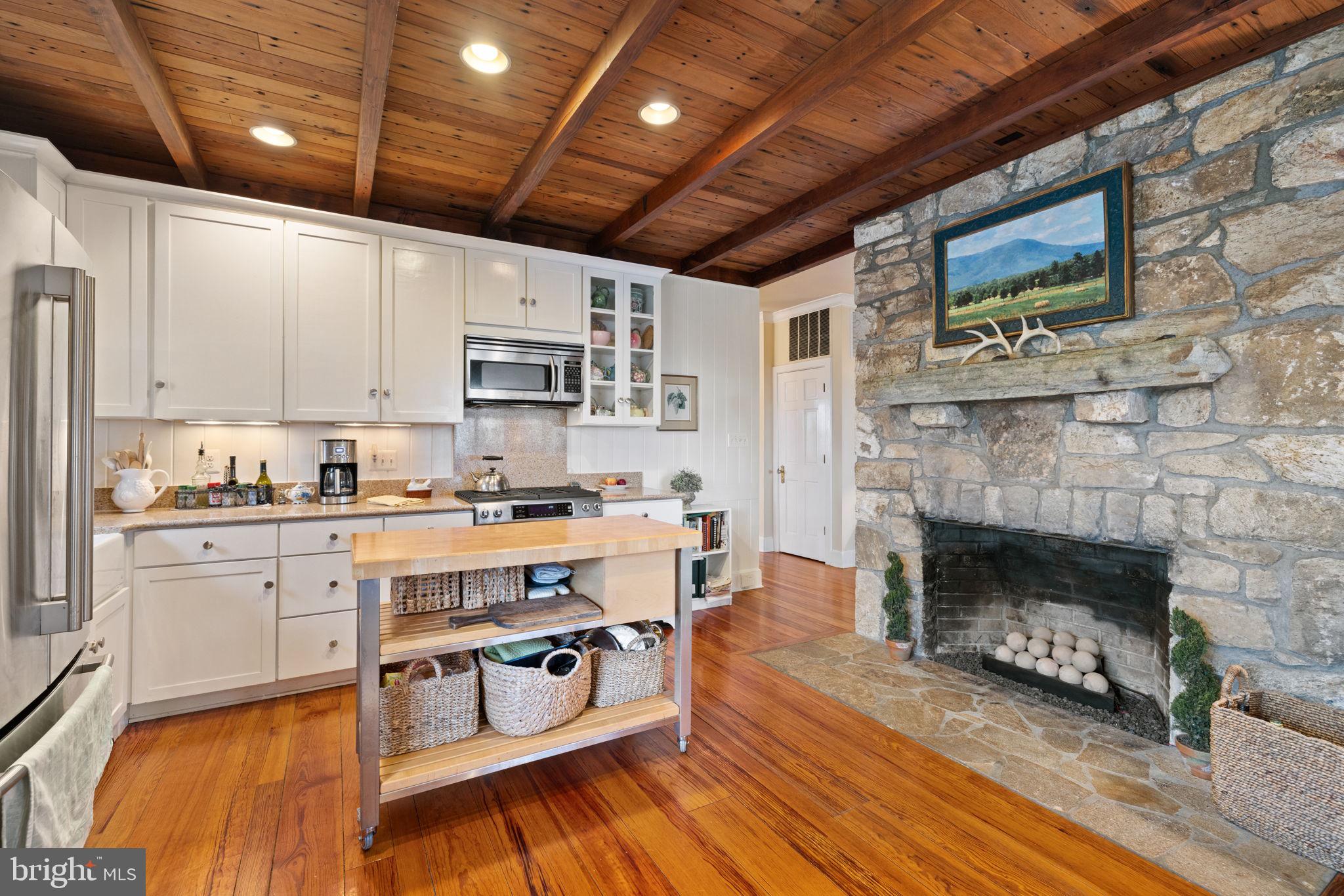 2294 Leeds Manor Road Markham, VA 22643 - Photo 19 of 97 Stone fireplace in kitchen with gas feature