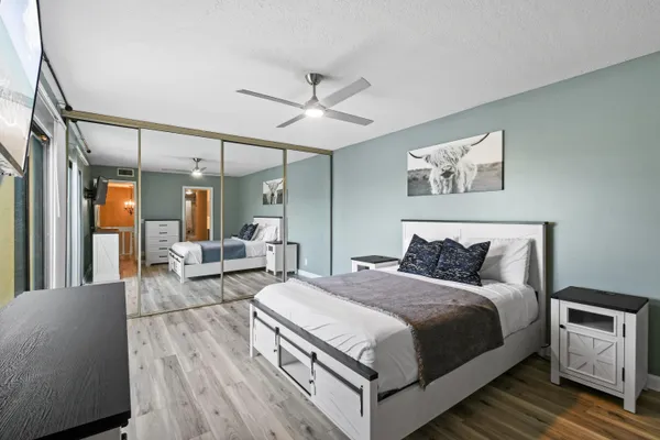 a bedroom with a large bed and a large window