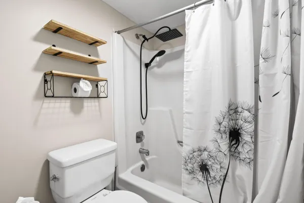 a bedroom with a bed and a ceiling fan