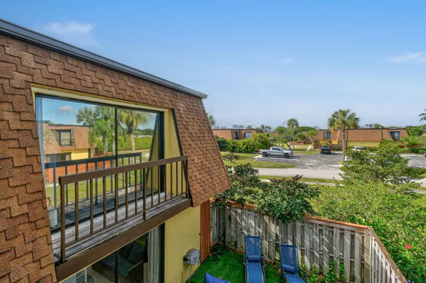 an outdoor view with swimming pool and lounge chair