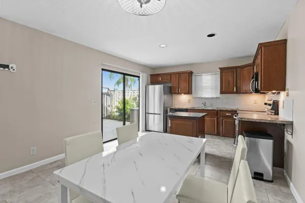 a kitchen with granite countertop a sink stove and refrigerator