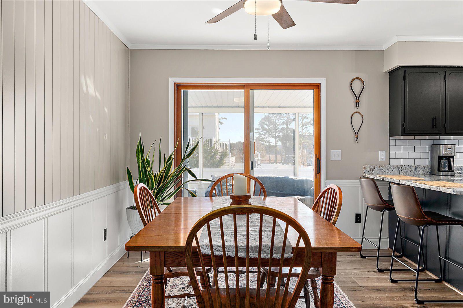 30069 Cedar Neck Road Ocean View, DE 19970 - Photo 11 of 61 a view of a a dining room with furniture window and wooden floor