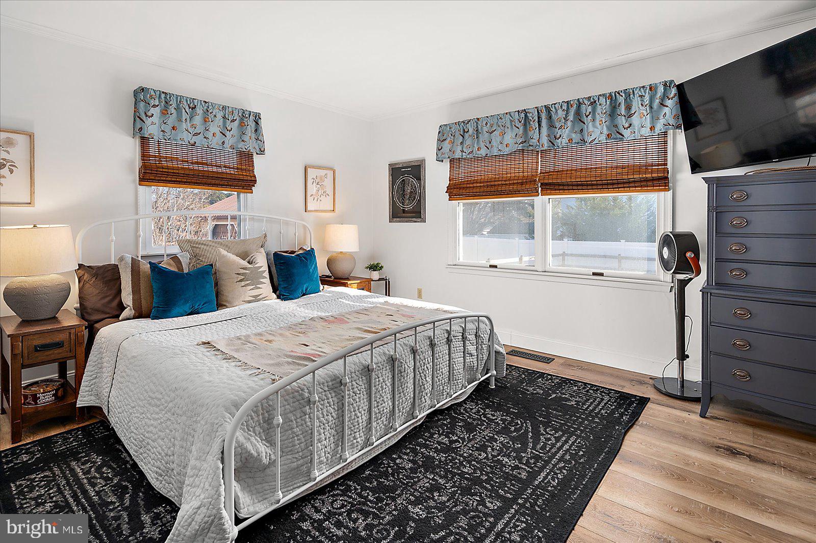 30069 Cedar Neck Road Ocean View, DE 19970 - Photo 16 of 61 a bedroom with a bed and wooden floor