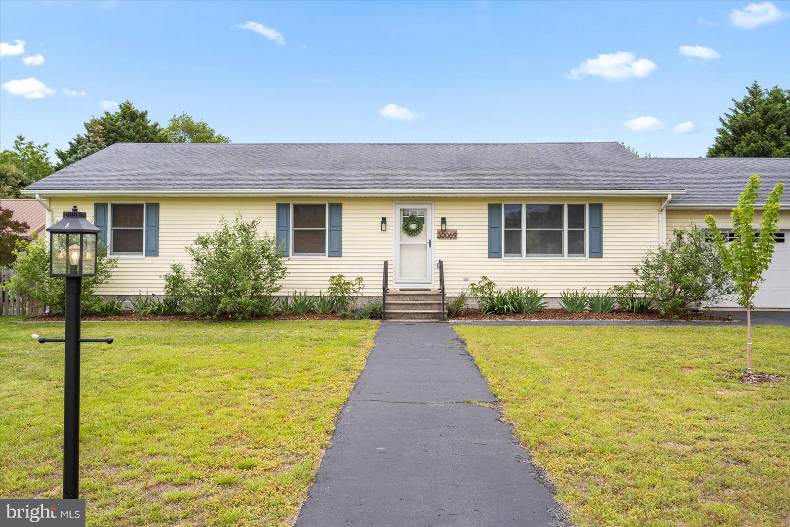 30069 Cedar Neck Road Ocean View, DE 19970 - Photo 2 of 61 a front view of house with yard and lake view