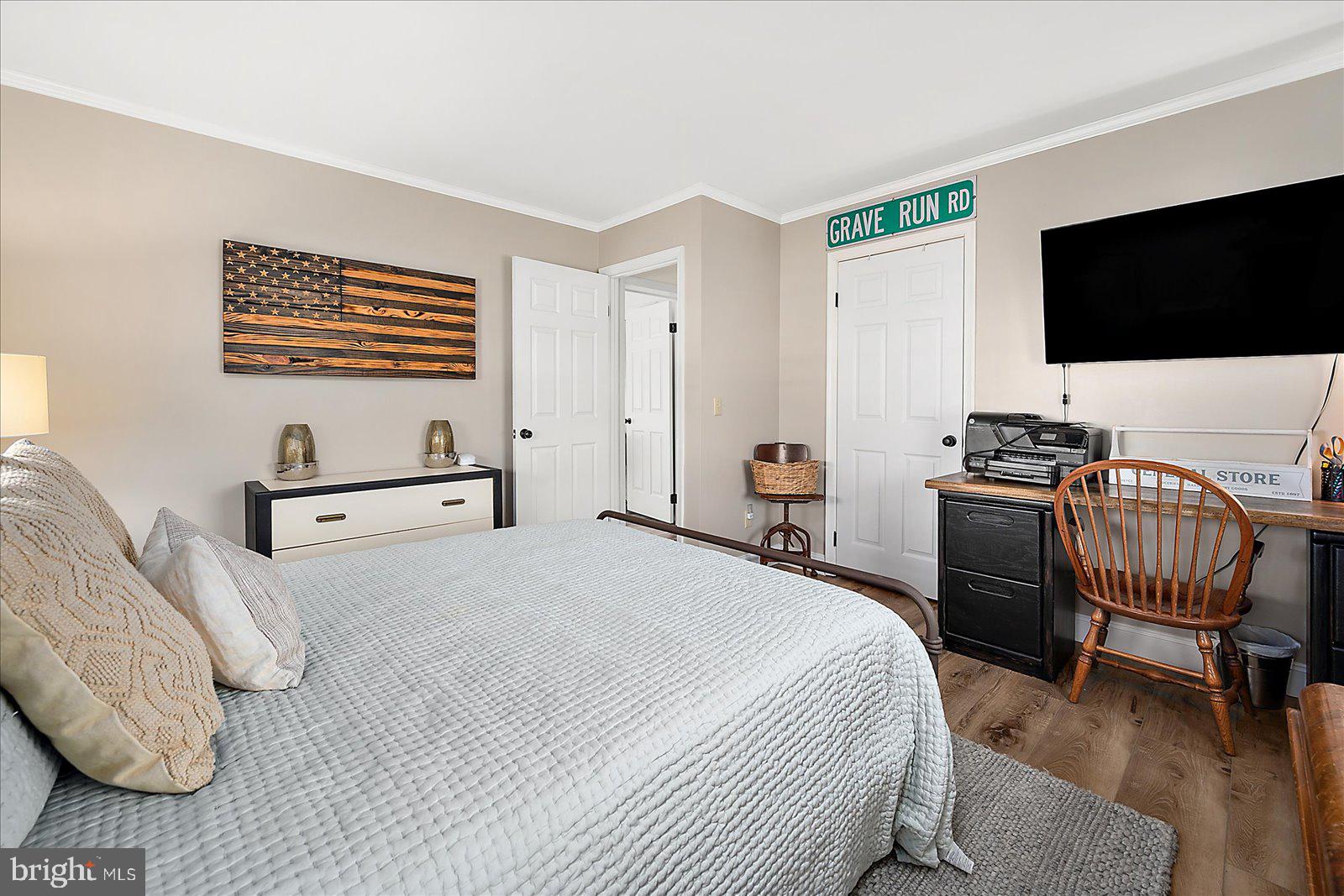 30069 Cedar Neck Road Ocean View, DE 19970 - Photo 21 of 61 a bedroom with a bed and a flat screen tv