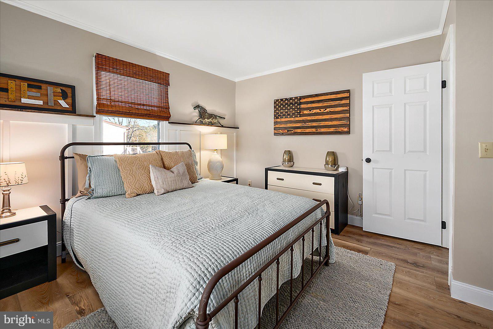 30069 Cedar Neck Road Ocean View, DE 19970 - Photo 22 of 61 a bedroom with a bed and a night stand
