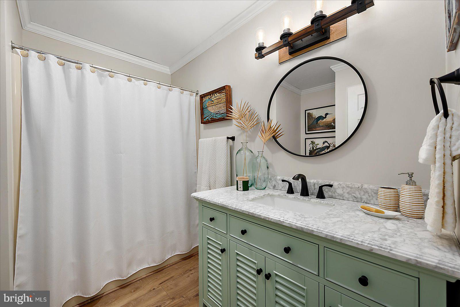 30069 Cedar Neck Road Ocean View, DE 19970 - Photo 23 of 61 a bathroom with a granite countertop sink and a mirror