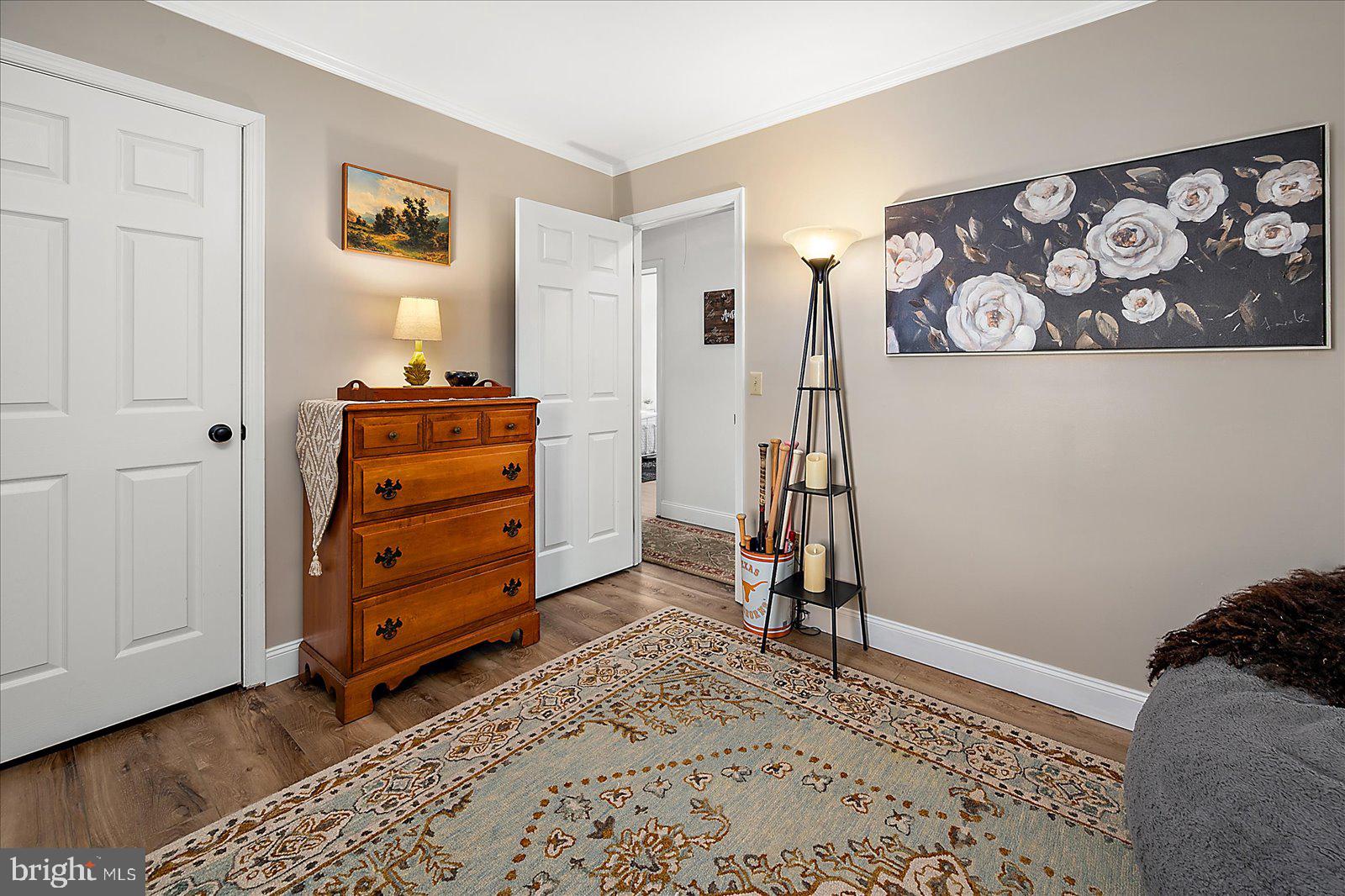 30069 Cedar Neck Road Ocean View, DE 19970 - Photo 26 of 61 a view of a bedroom with baby crib and lounge chair