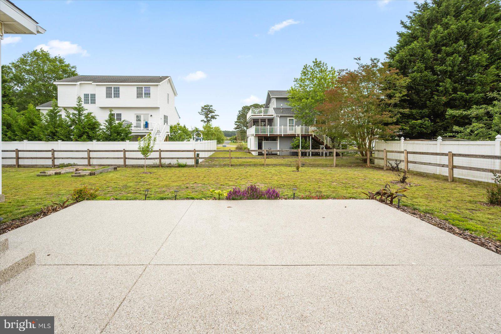 30069 Cedar Neck Road Ocean View, DE 19970 - Photo 34 of 61 a view of a swimming pool and a yard