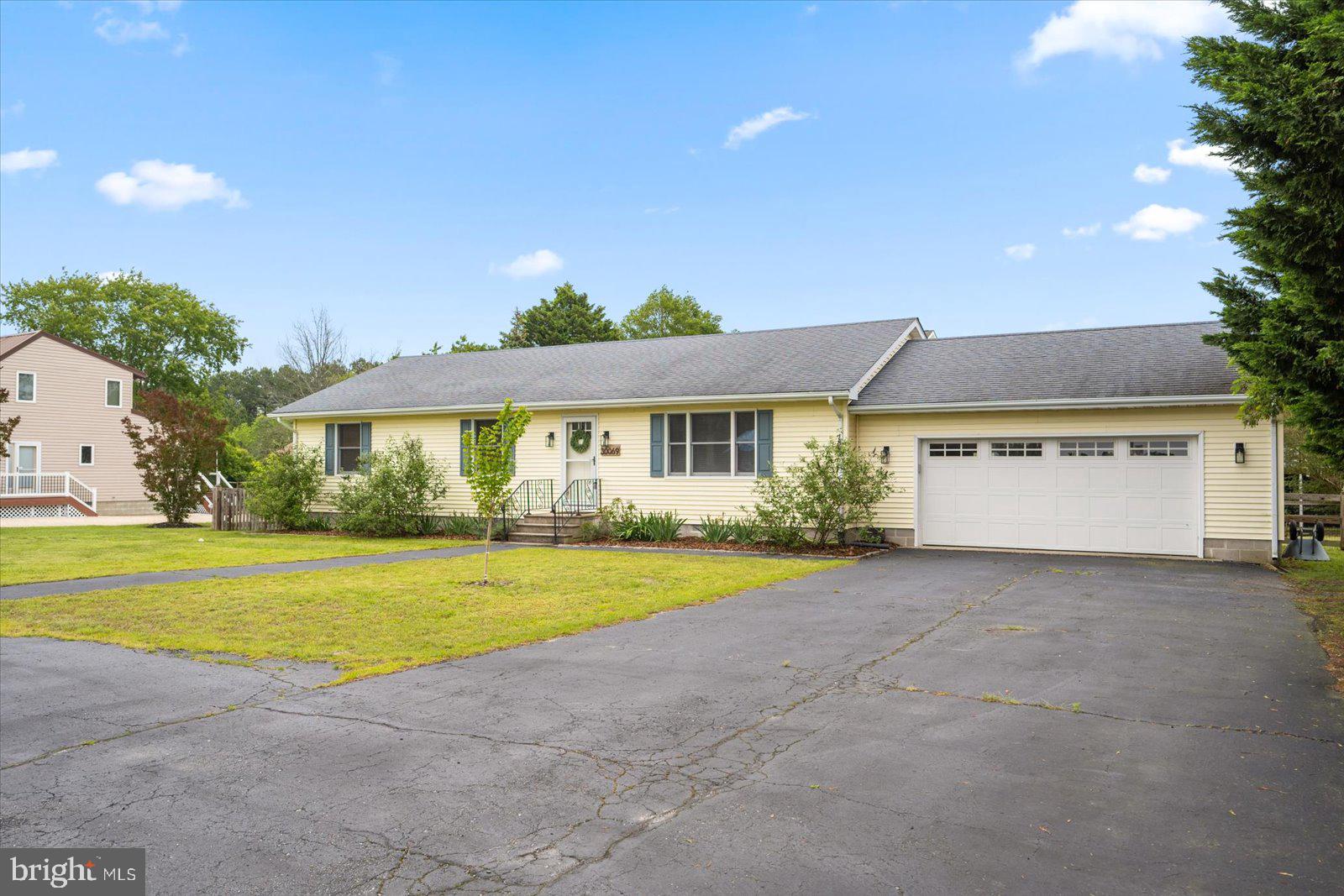 30069 Cedar Neck Road Ocean View, DE 19970 - Photo 41 of 61 a front view of a house with a yard and garage