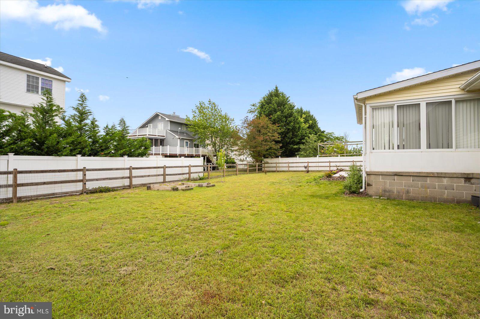 30069 Cedar Neck Road Ocean View, DE 19970 - Photo 42 of 61 a view of a swimming pool with an outdoor space and seating area