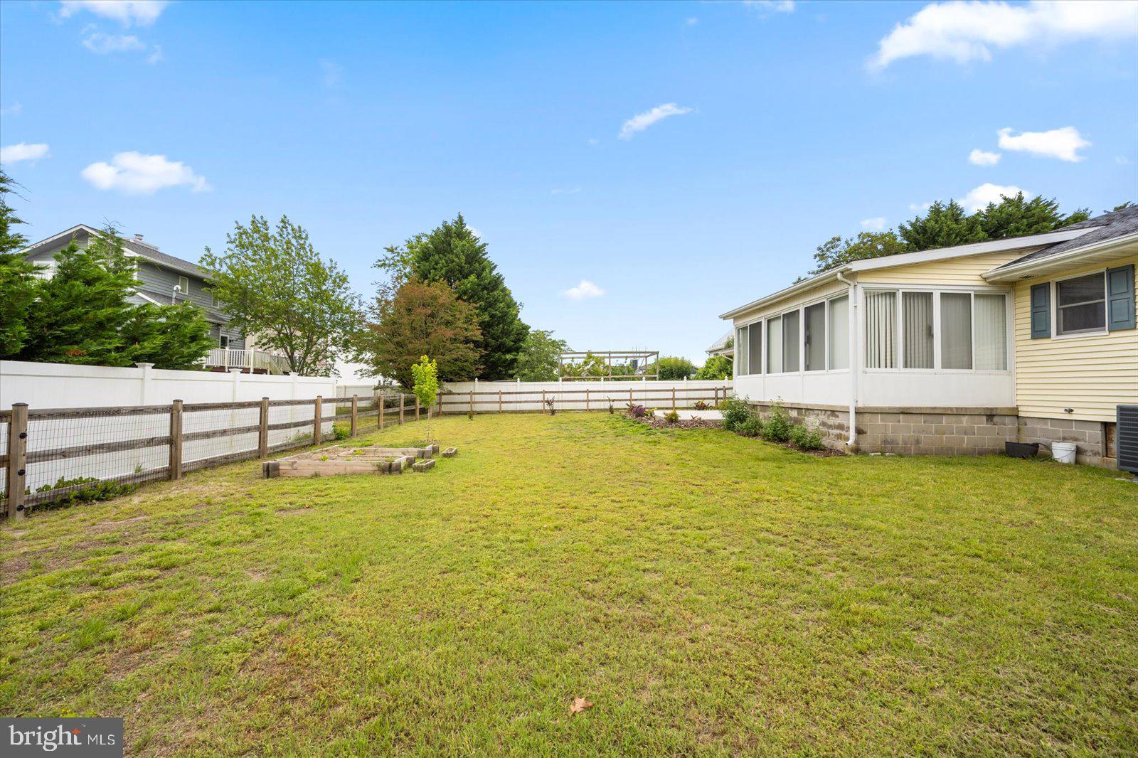 30069 Cedar Neck Road Ocean View, DE 19970 - Photo 43 of 61 a view of a swimming pool with an outdoor seating and a garden