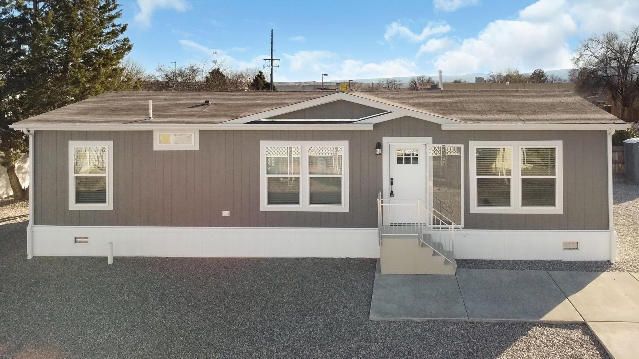 3195 F Road, Unit 8 Grand Junction, CO 81504 - Photo 1 of 26 a front view of a house with a yard