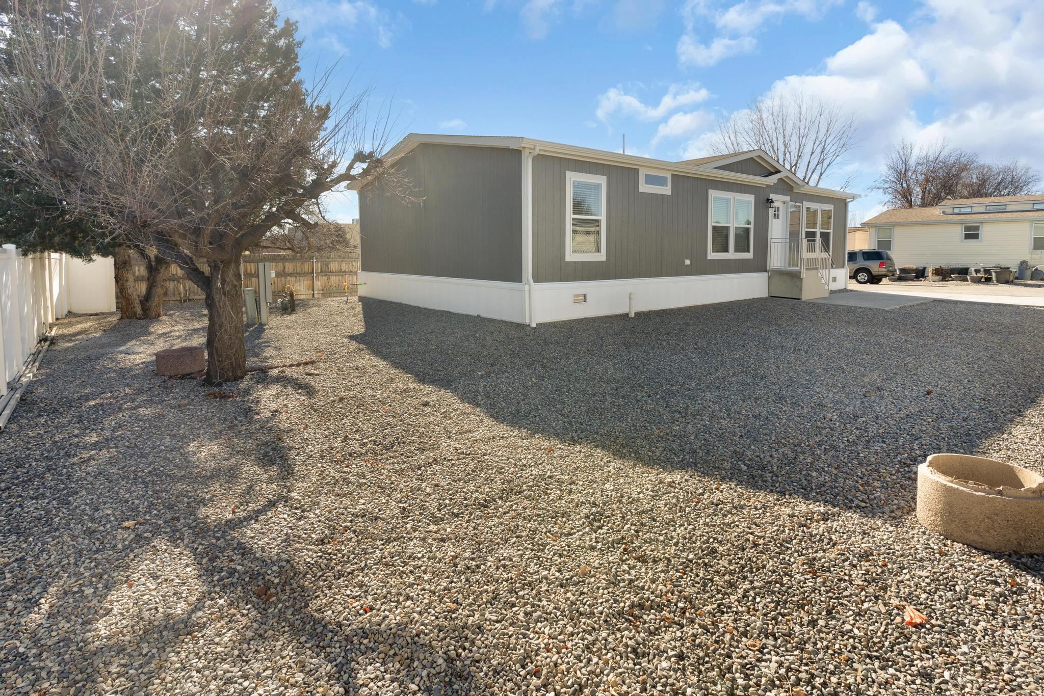3195 F Road, Unit 8 Grand Junction, CO 81504 - Photo 23 of 26 a front view of a house with a yard