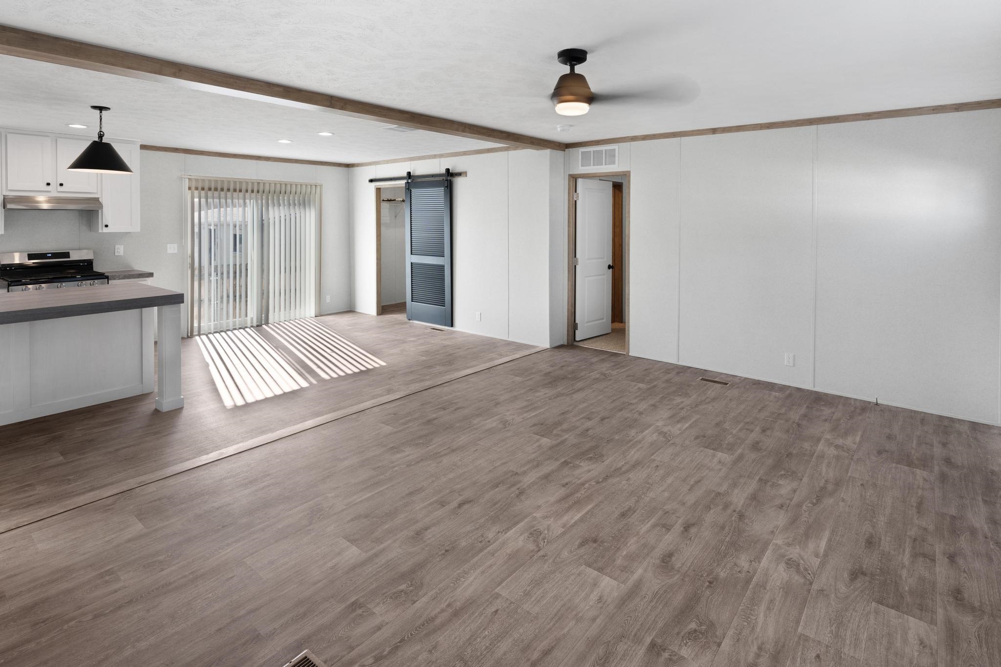 3195 F Road, Unit 8 Grand Junction, CO 81504 - Photo 3 of 26 a view of an empty room with window and wooden floor
