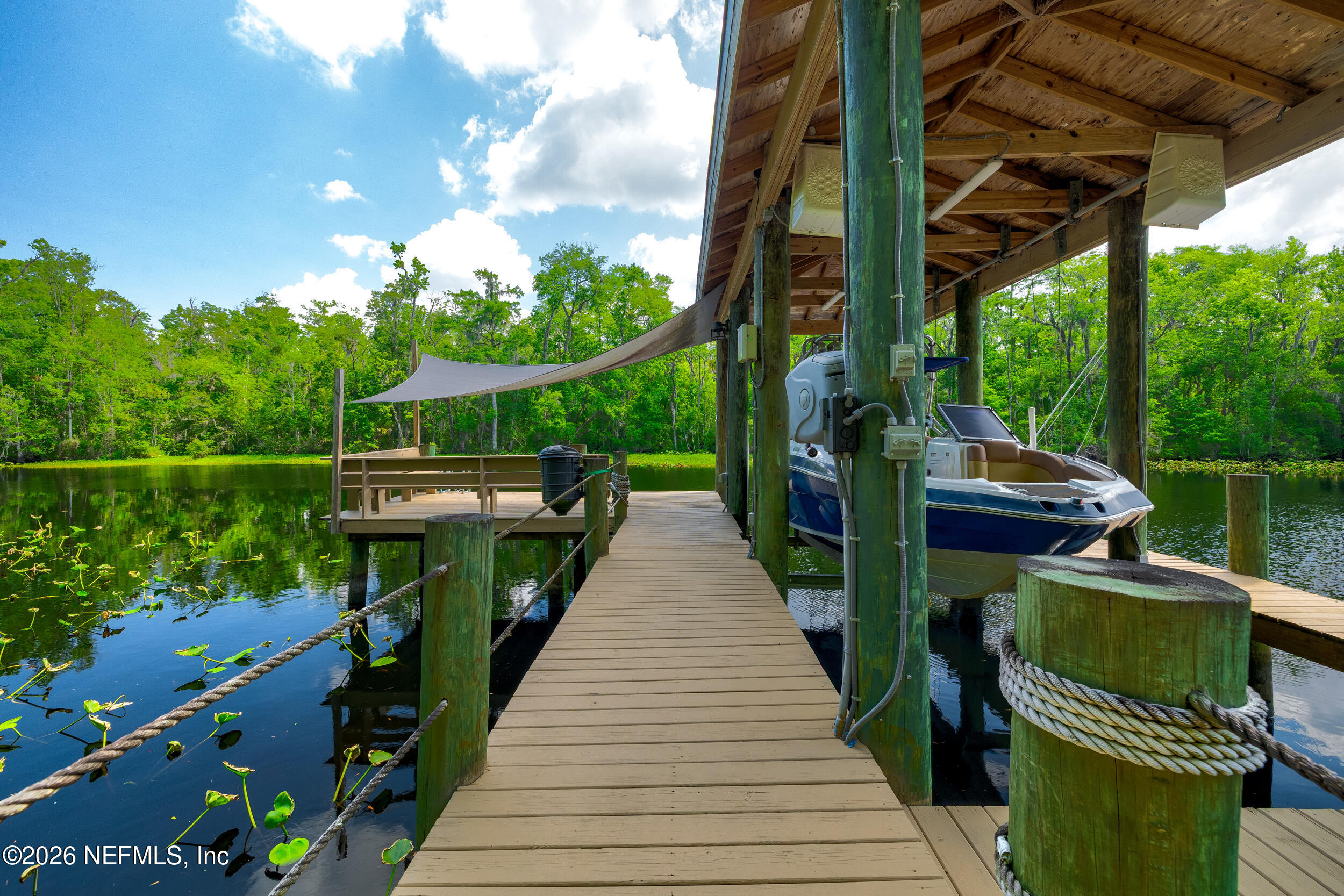 3225 Bishop Estates Road St. Johns, FL 32259 - Photo 64 of 90 a view of a deck and chair under an umbrella with the trees